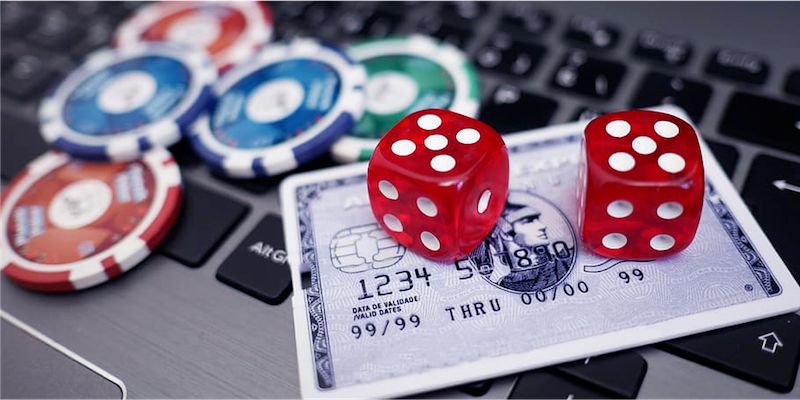 Poker chips and cards on a bank card; JackpotCity Casino Blog
