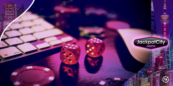 Jackpot City themed image with a keyboard, mouse, casino dice and chips