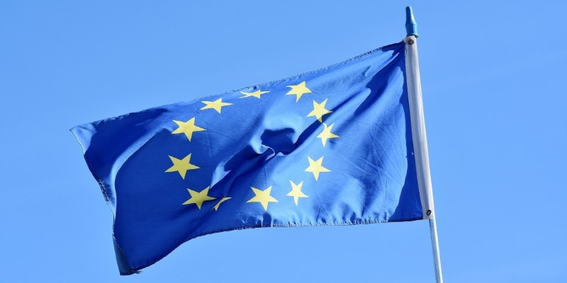 The European flag flying against a clear blue sky.