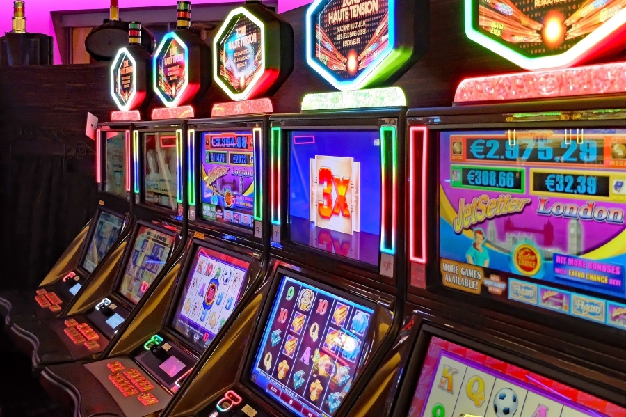 A line-up of slot machines inside a casino; JackpotCity Casino Blog