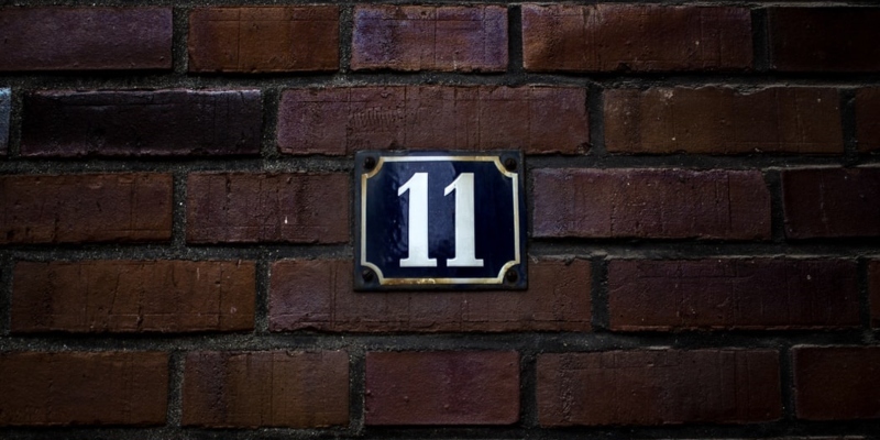 Brick wall with number 11 sign 