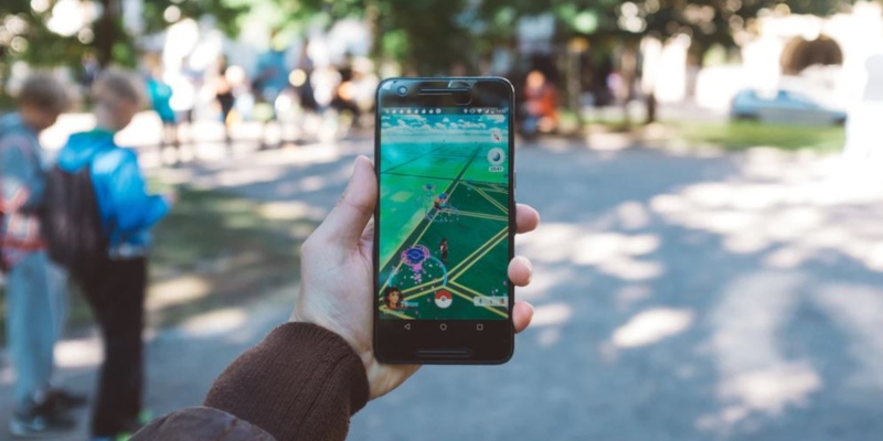 Person playing Pokemon Go in a park; Spin Casino blog