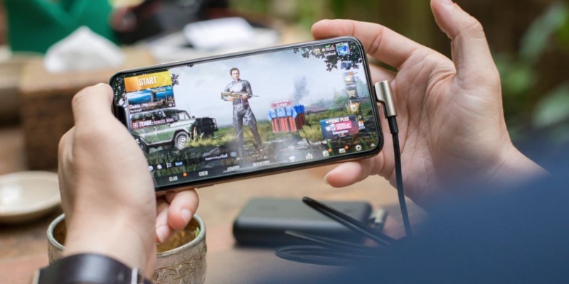 Person playing PUBG on a mobile phone; Spin Casino blog