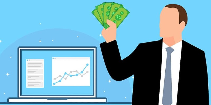 Cash in hand with analytics on laptop