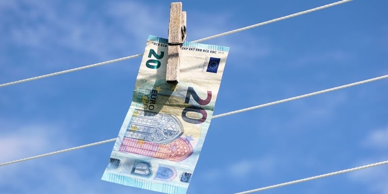 A Euro note hanging on a clothesline - Spin Palace Blog