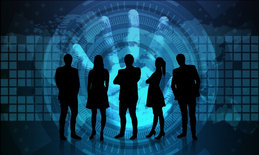 Silhouettes of people standing in front of cybersecurity imagery.