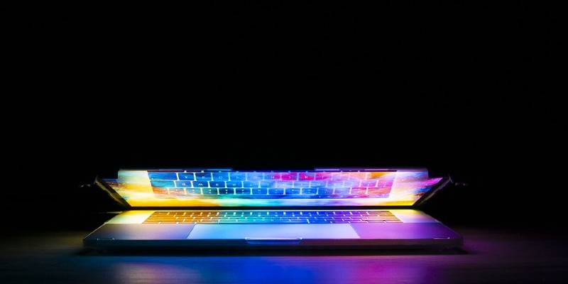 Open laptop lit up on dark background