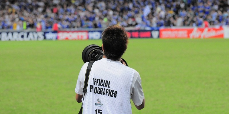 Sports photographer at football match
