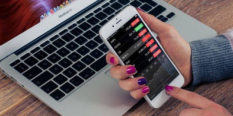 Woman trading stocks on a smartphone app